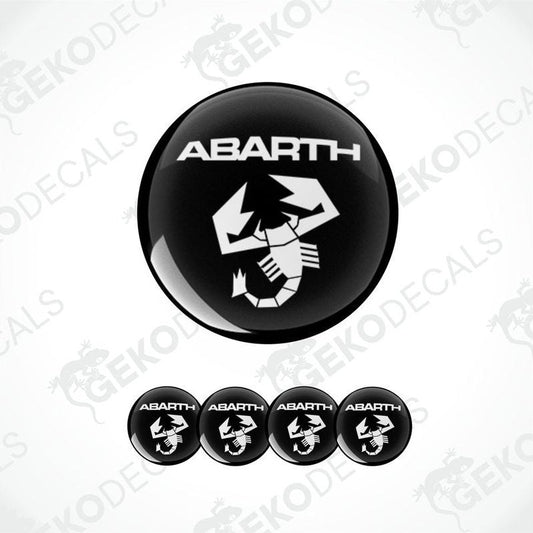 A set of four black and white vinyl stickers with the word 'ABARTH' printed on them.