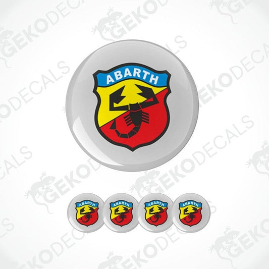 A set of four round car decals with the Abarth logo, featuring a red and yellow shield with a scorpion emblem in the center.