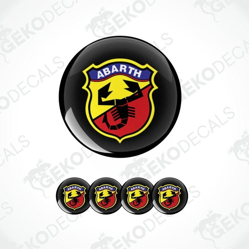 A set of four round vinyl stickers with a geometric design featuring the ABARTH logo in red, yellow, and black colors.