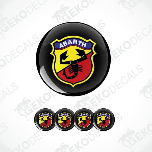 A set of four round vinyl stickers with a geometric design featuring the ABARTH logo in red, yellow, and black colors.
