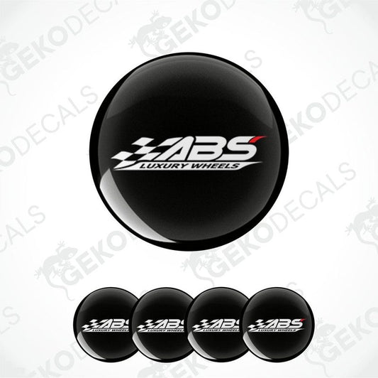 A set of four black vinyl stickers with the text 'ABS Luxury Wheels' and a logo depicting a racing flag.