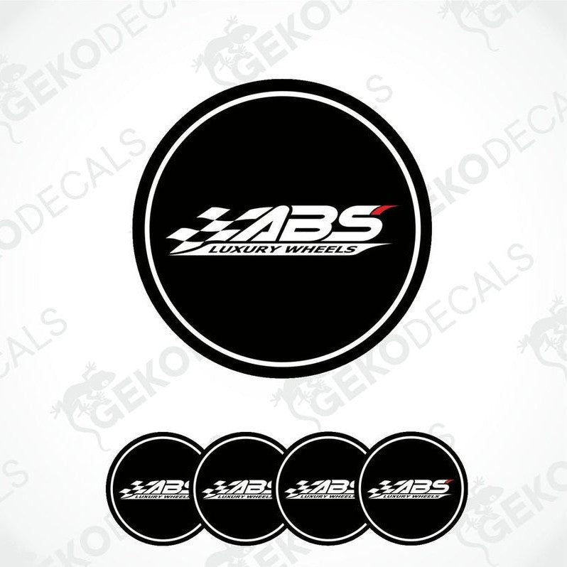 A set of four round black vinyl stickers with the text 'ABS Luxury Wheels' in white and red.