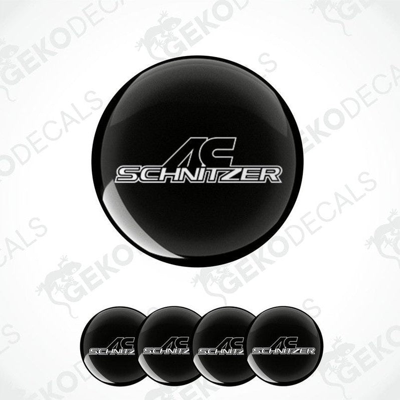 Set of four black vinyl decals with the 'AC Schnizer' logo in white, designed for use on car wheel caps.