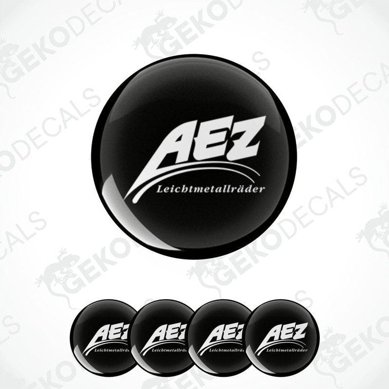 A set of four black and white vinyl decals with the AEZ LEICHTMETALLRÄDER logo.