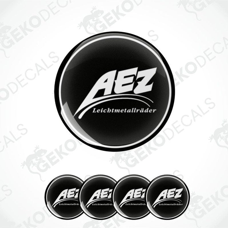 A set of four black and white vinyl decals with the AEZ LEICHTMETALLRÄDER logo.