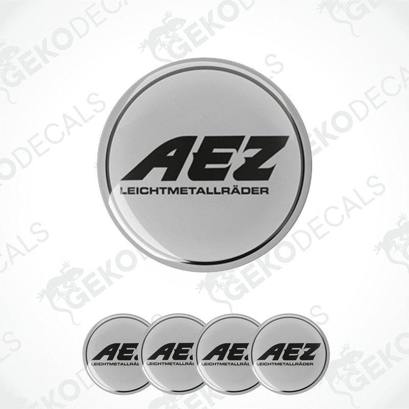 A set of four grey vinyl stickers with the AEZ brand logo, designed for use as car decals.