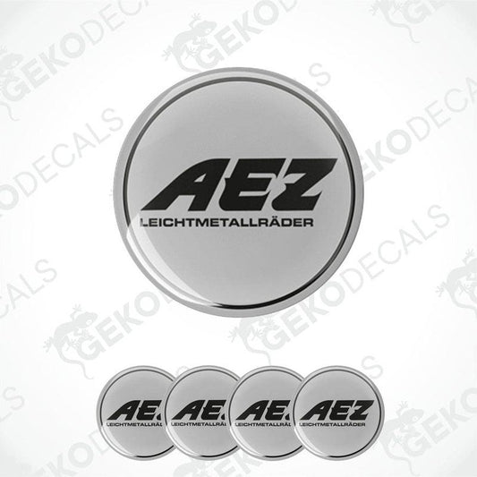 A set of four grey vinyl stickers with the AEZ brand logo, designed for use as car decals.