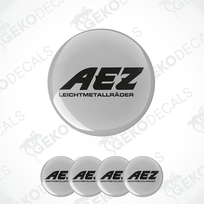 Set of four grey vinyl decals with the AEZ logo in black, designed for use on vehicle wheels.