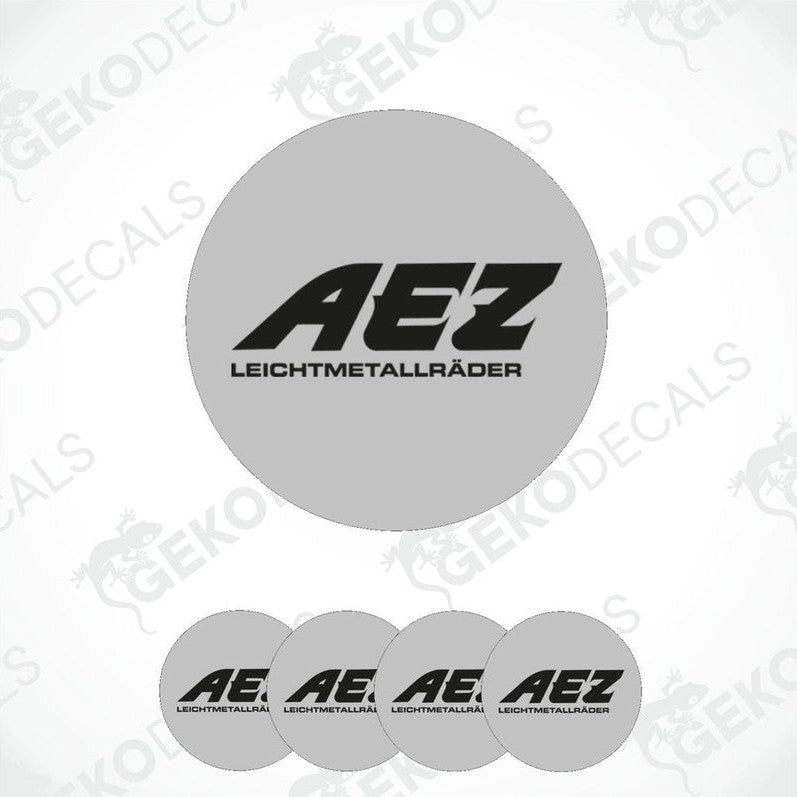 Set of four grey vinyl decals with the AEZ logo in black, designed for use on vehicle wheels.
