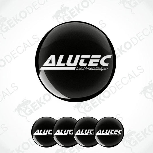 A set of four black dome-shaped vinyl stickers with the white text 'ALUTEC' on them.