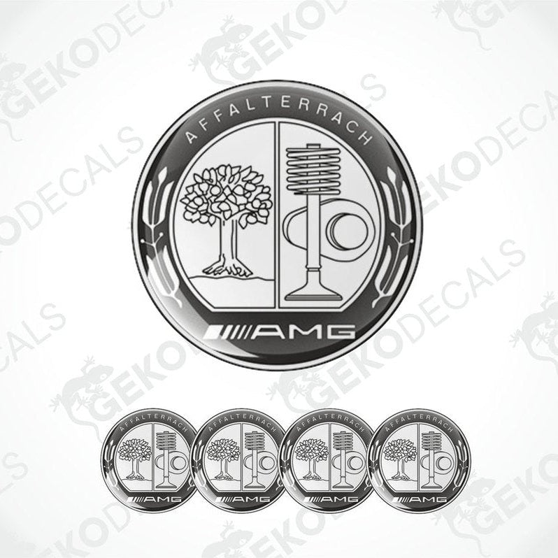 A set of four silver-colored vinyl stickers with a polyurethane coating, featuring the AMG logo and a design that includes a tree and a microphone.