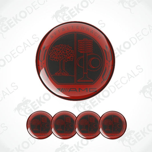 A set of four red vinyl stickers with a geometric design and the word 'AMG' on them, arranged on a white background.