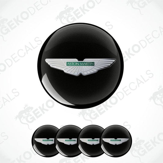 A set of four black vinyl stickers with a white Aston Martin logo on each.