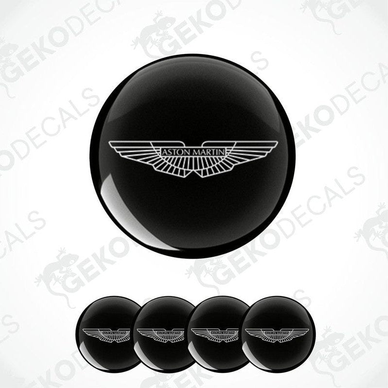 A set of four black vinyl stickers with a geometric design, including the Aston Martin logo.