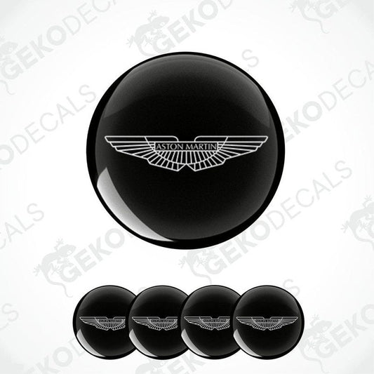 A set of four black vinyl stickers with a geometric design, including the Aston Martin logo.