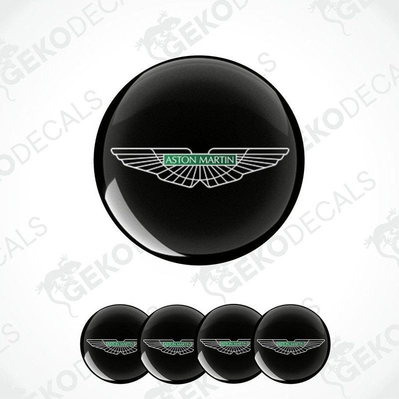 A set of vinyl decals with the Aston Martin logo applied on a black surface and shown in isolation against a white background.