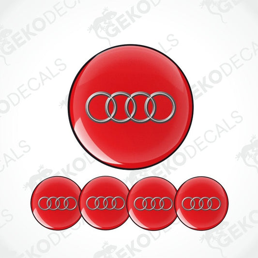 A set of four red vinyl stickers with a white Audi logo, designed for use as car decals.