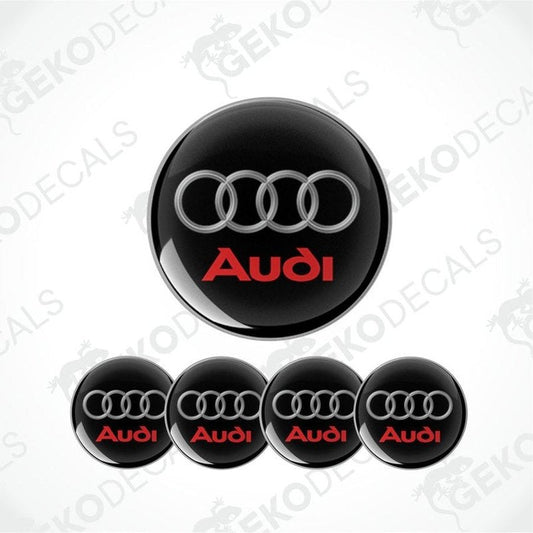 A set of four black vinyl stickers with the word 'AUDI' in red, displayed on a white background.