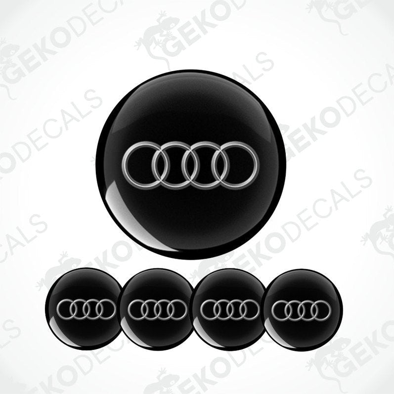 Set of vinyl decals with the Audi logo applied on a black background, intended for use as car stickers.