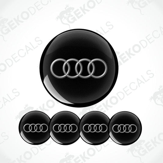 Set of vinyl decals with the Audi logo applied on a black background, intended for use as car stickers.