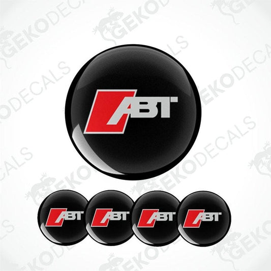 A set of four round car decals with the AUDI ABT logo in red and white on a black background.