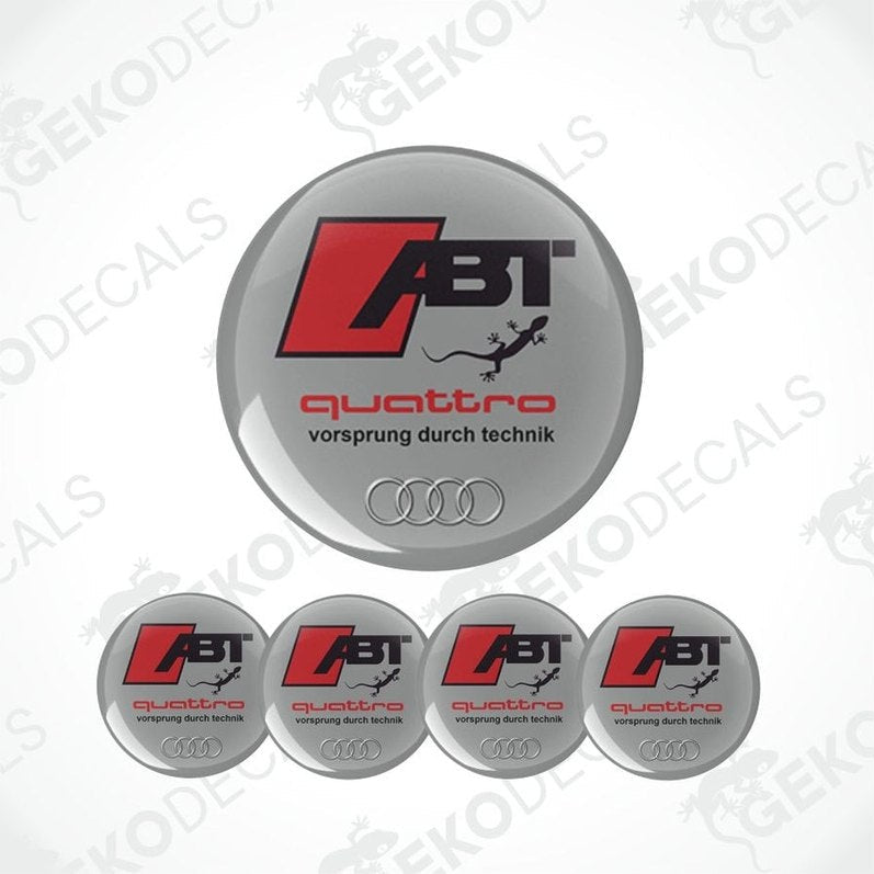 Set of four Audi ABT Quattro wheel decals with a silver, red, and black color scheme and the text 'quattro' and 'vorsprung durch technik'.