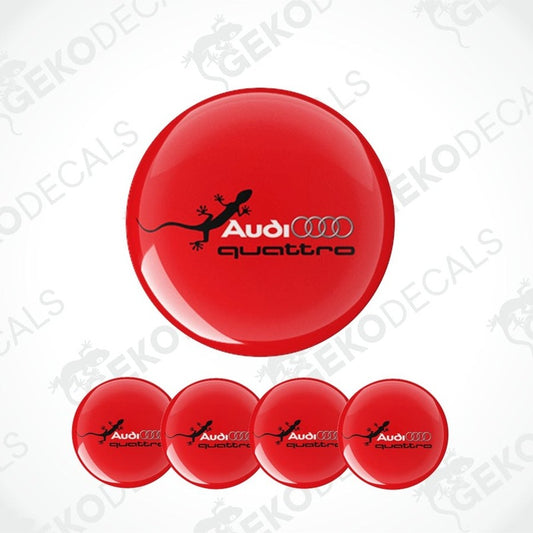 A set of red vinyl decals with the Audi Quattro logo, including one larger decal and four smaller ones arranged in a row.
