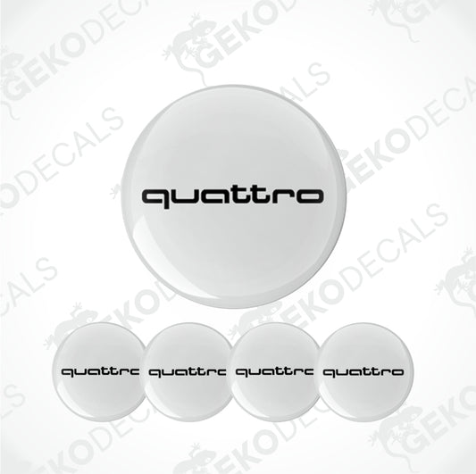 A set of white vinyl decals with the word 'quattro' printed on them, typically used as car wheel decals.