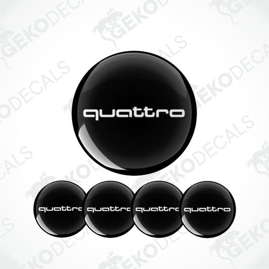 Set of four black vinyl decals with 'quattro' branding, designed for use as car wheel caps or stickers.