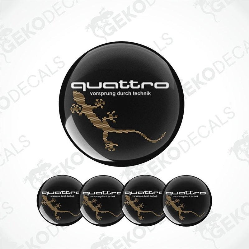 Set of four black round car decals with the 'quattro' logo in gold, and one additional decal with a lizard image.
