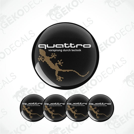 Set of four black round car decals with the 'quattro' logo in gold, and one additional decal with a lizard image.