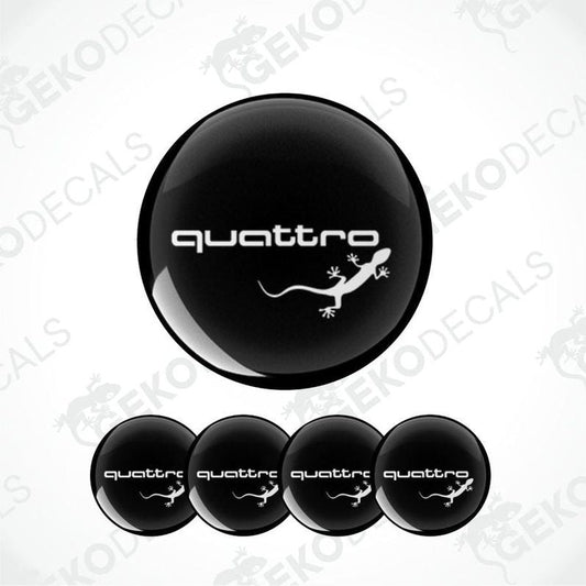 A set of four black vinyl stickers with the word 'AUDI QUATTRO' and an image of a lizard. 
