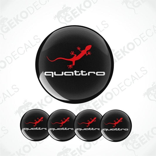 A set of four black vinyl stickers with red accents and the word 'QUATTRO' printed on them, designed for use on vehicle wheel caps.