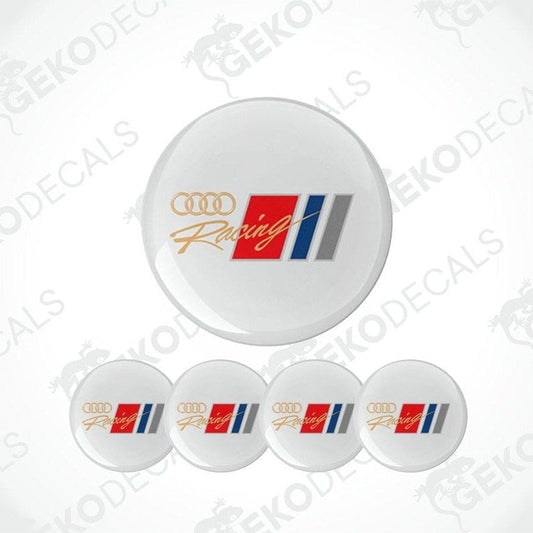 A set of four white round car decals with 'Audi Racing' logo in red, blue, and gray.