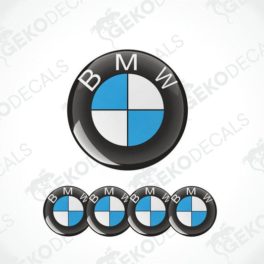 A set of four BMW-branded vinyl stickers with a polyurethane coating, displayed on a white background. The stickers are in blue, black, and white colors with the BMW logo in the center.