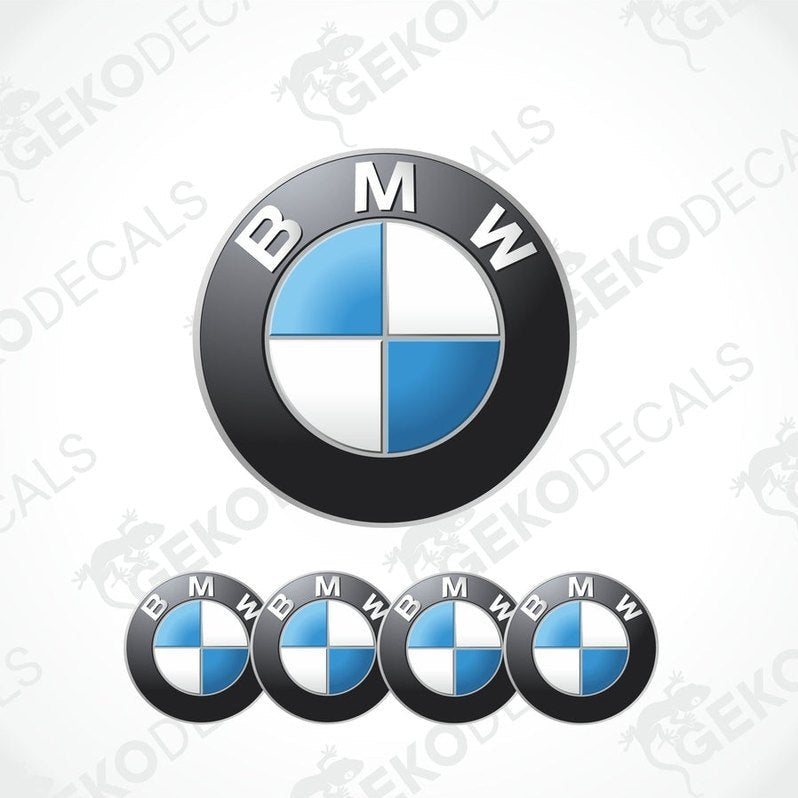 A set of four BMW emblem stickers, with one large emblem in the center and three smaller ones around it, all in black, blue, and white colors.