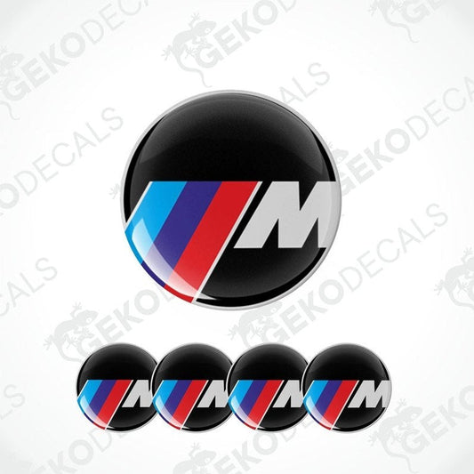 A set of four vinyl decals with a polyurethane coating featuring the BMW M logo in black, red, blue, and white colors.