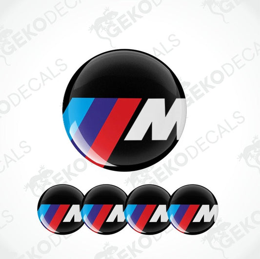 A set of four vinyl decals with a polyurethane coating featuring the BMW M logo in black, red, blue, and white colors.