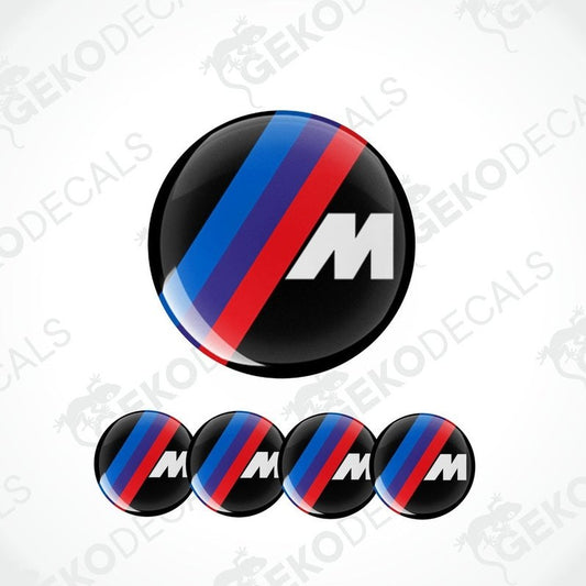 A set of four round vinyl stickers with a black center featuring a red and blue stripe and the letter ' BMW M' on a white background.