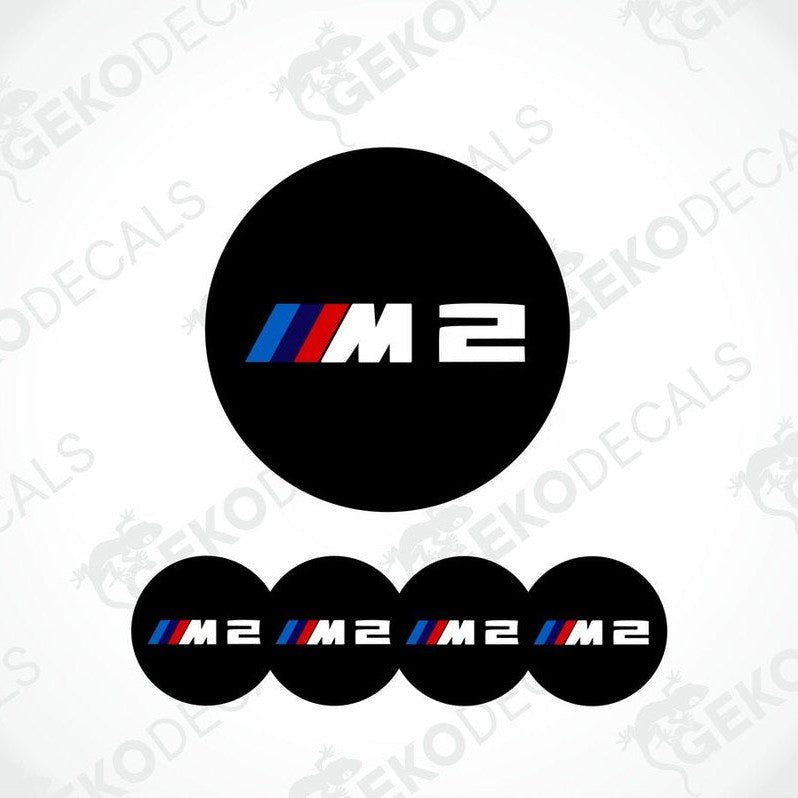 A set of four black vinyl stickers with the BMW M2 logo, displayed on a white background.
