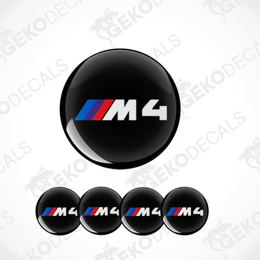 A set of four round car decals with the BMW M4 logo in black, blue, and red.