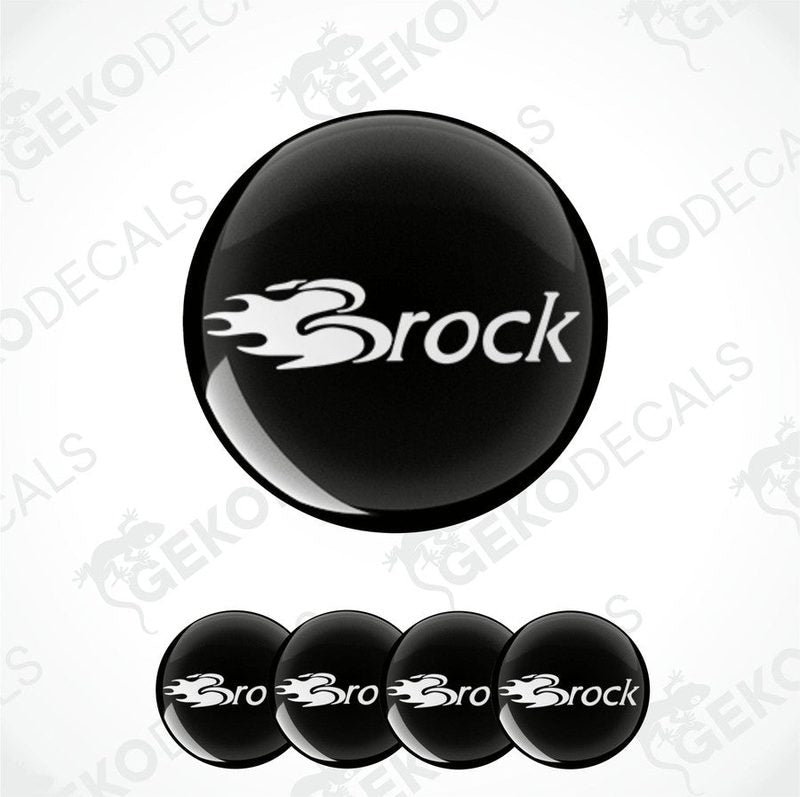 A set of four black vinyl stickers with the word 'BROCK' printed on them, arranged stacked on top of each other.