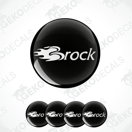 A set of four black vinyl stickers with the word 'BROCK' printed on them, arranged stacked on top of each other.