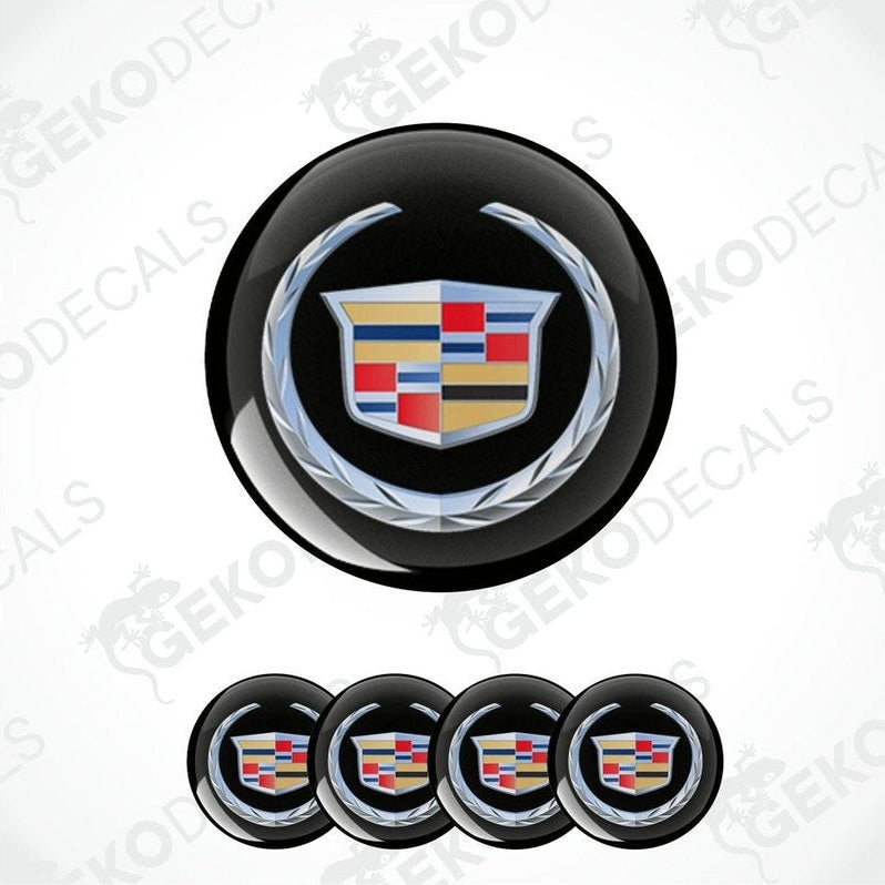 A set of four black round car decals with the Cadillac logo in the center.