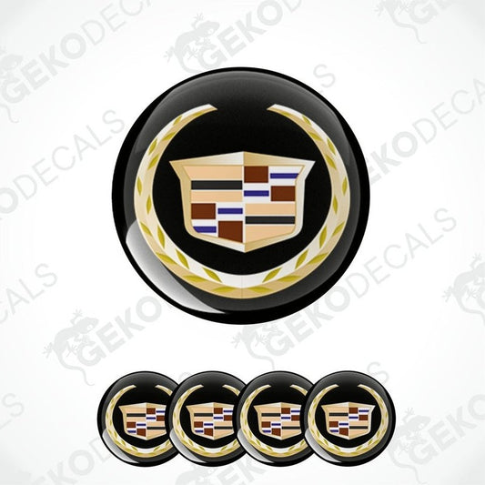 A set of four vinyl decals with a Cadillac logo design, featuring a black background with gold and multicolor accents.