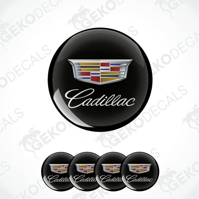 A set of four black round car decals with the Cadillac logo in the center.