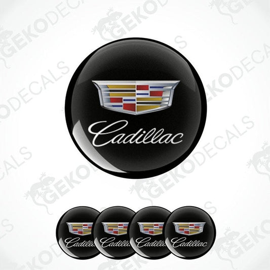 A set of four black round car decals with the Cadillac logo in the center.