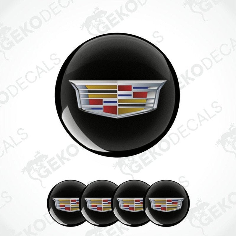 Set of four black vinyl decals with a Cadillac logo applied on them, designed for use as car wheel caps.