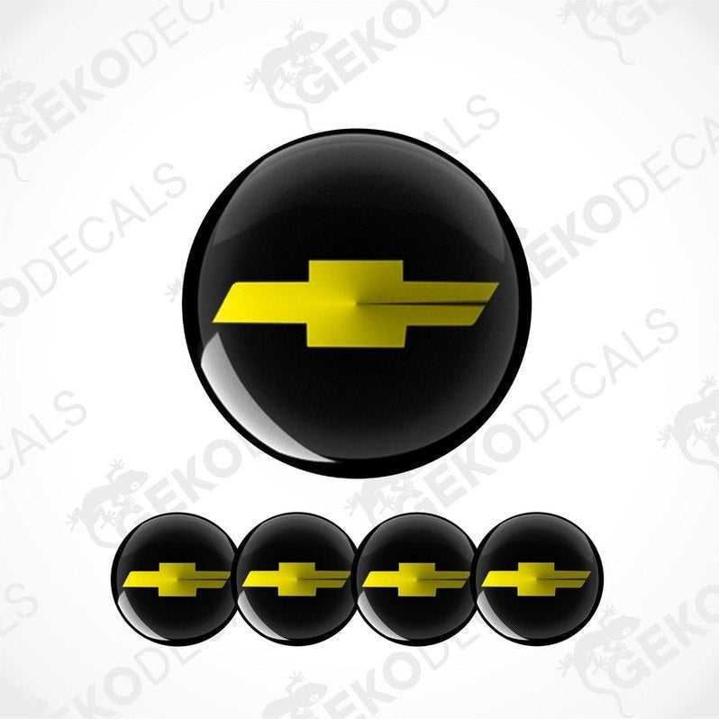 A set of four black vinyl stickers with a yellow Chevrolet logo on them.