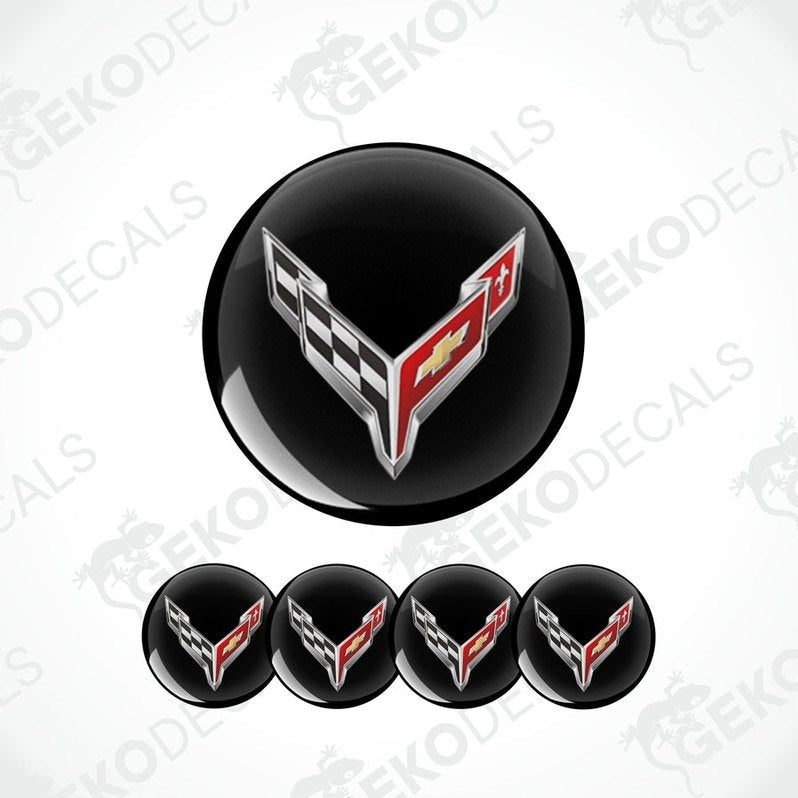 A set of four black vinyl stickers with a checkered pattern and the Chevrolet Corvette logo in the center.